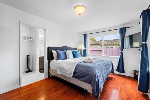 a bedroom with a bed and a large window at 1580 - SFO Spacious & Beautiful 3BR house in Milbrae in Millbrae