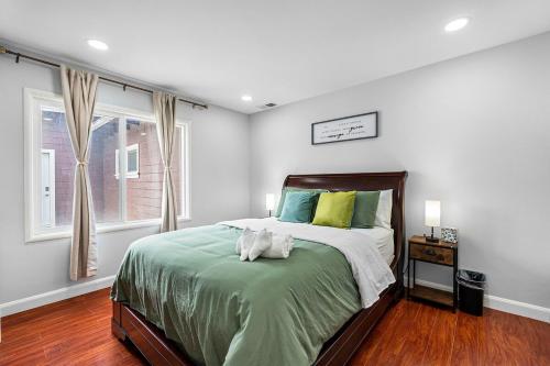 a bedroom with a bed with a cat laying on it at 1580 - SFO Spacious & Beautiful 3BR house in Milbrae in Millbrae
