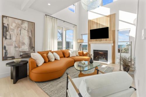 a living room with a couch and a fireplace at Pocasset Family retreat ocean view in Bourne