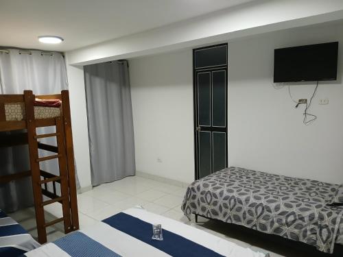 Ένα ή περισσότερα κρεβάτια σε δωμάτιο στο Hotel Magu Huarmey