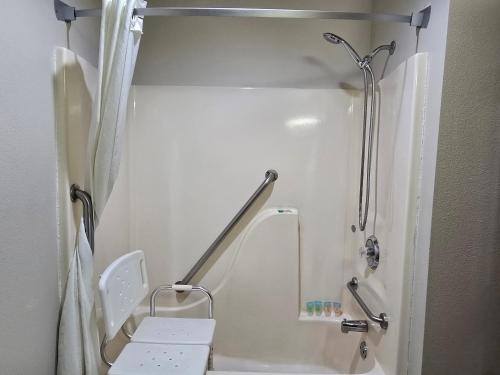 a small bathroom with a shower and a toilet at AmeriVu Inn and Suites Shawano WI in Shawano