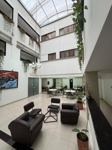 a lobby with couches and tables in a building at Hotel Catalina Plaza Pereira in Pereira