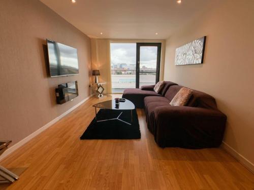 a living room with a couch and a table at Glasgow 2bd near Hydro SECC City Centre Great Location in Glasgow