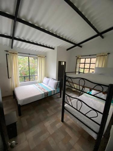 a bedroom with two bunk beds and a window at CASALOMA in La Vega