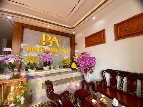 a restaurant with vases of flowers on the counter at Phi Anh Hotel in Bình Minh