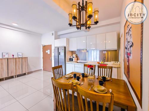 a kitchen and dining room with a wooden table and chairs at Pangsapuri Meridian by RR JBcity in Nusajaya
