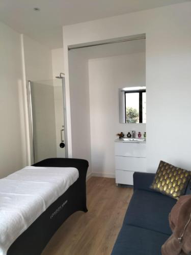 a bedroom with a bed and a window and a couch at Le Palais Secret 66 Loveroom in Saint-Féliu-dʼAvall