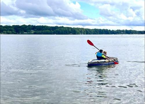 two people in a paddle boat on a lake at Modern 4bedrooms Home Near Lake Decatur in Decatur