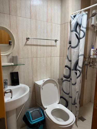 a small bathroom with a toilet and a sink at Modern Condo in Ermita Manila near US Embassy and SLMEC in Manila