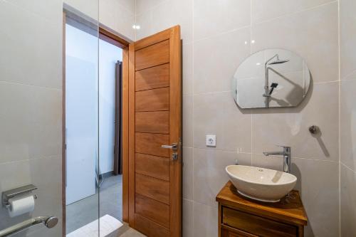 a bathroom with a sink and a mirror and a shower at Standart Room in Sanur