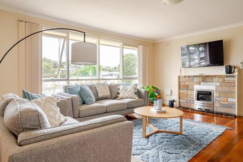 a living room with a couch and a table at Charming Old Rye House Retreat in Rye