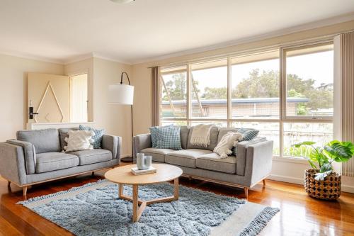a living room with two couches and a table at Charming Old Rye House Retreat in Rye