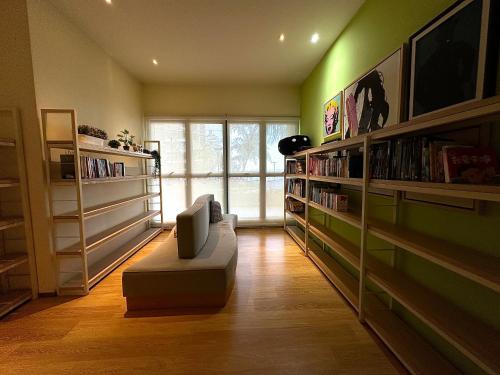 a room with a library with bookshelves and a couch at Astonishing Ocean View 3 Bedroom Apartment in Johor Bahru
