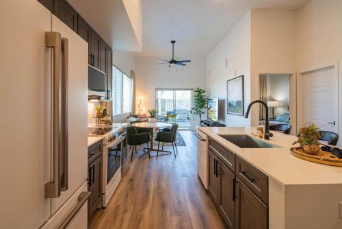 a kitchen with a sink and a dining room at Rooftop Deck, Heated Pool Nearby Golf & Sun Stay in Scottsdale