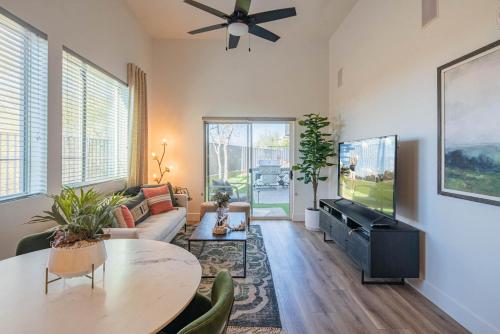 a living room with a couch and a table at Phoenix Stay , Near Mayo Clinic & Shopping, Pool & Parking- S134 in Scottsdale