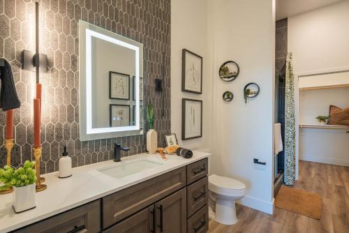 a bathroom with a sink and a toilet and a mirror at Rooftop Deck, Heated Pool Nearby Golf & Sun Stay in Scottsdale