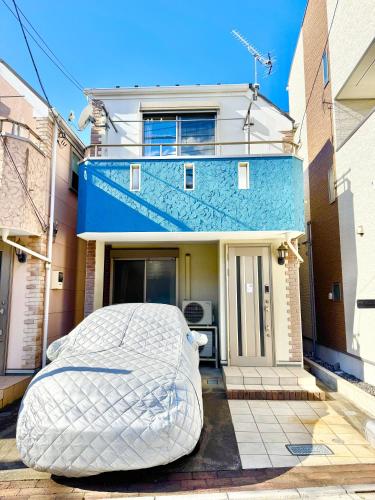 a mattress is sitting in front of a house at ansok青井 一軒家を改装した清潔なホステル 個室 in Tokyo