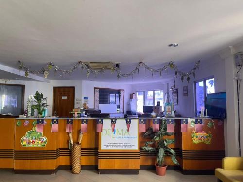 an office with a bar with a christmas decoration at Capital O 91107 Pd Tiara By Delima Suites in Kampong Batu Empat Belas