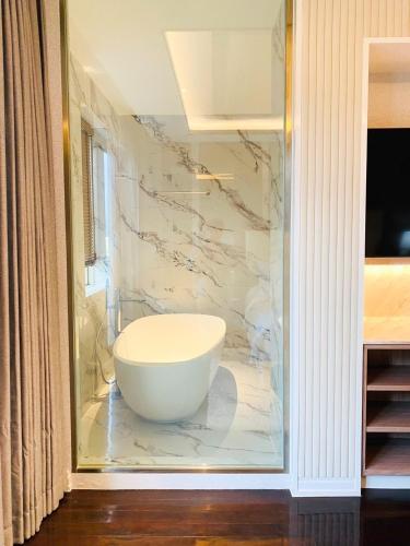 a bathroom with a large white bowl on a wall at La Plante Siem Reap in Siem Reap