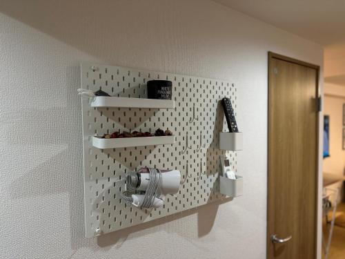 a wall mounted dispenser on a wall at 新宿神楽坂近く寿司店2 in Tokyo