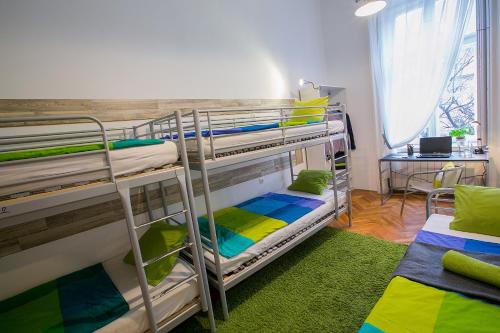 a room with two bunk beds and a desk at Friends Hostel & Apartments in Budapest