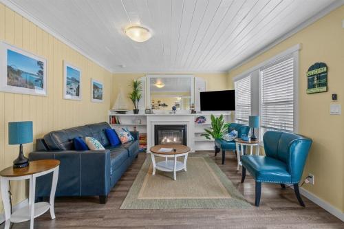 a living room with a blue couch and a fireplace at Harbor Lights in Lincoln City