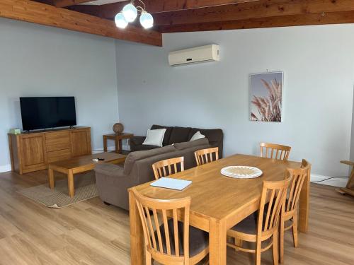 a living room with a table and a couch at 3 bdm Central Albany House in Albany