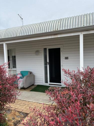 a couch sitting on the front porch of a house at 3 bdm Central Albany House in Albany