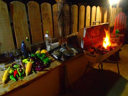 a counter with vegetables and a fire on it at Pavlosx2 in Chora Folegandros