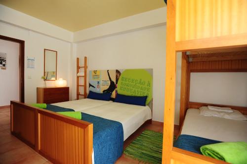 a bedroom with two beds and a bunk bed at Caparica Sun Centre in Costa da Caparica