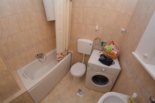 a bathroom with a toilet and a bath tub and a sink at Apartment Nikolic Kotor in Kotor