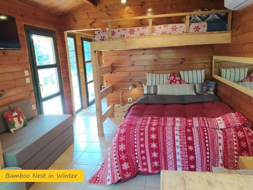 a bedroom with a bed in a wooden cabin at ΒΑΜΒΟΟ nest by the sea in Pálioura