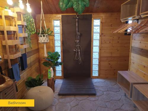 a room with a shower in a wooden cabin at ΒΑΜΒΟΟ nest by the sea in Pálioura