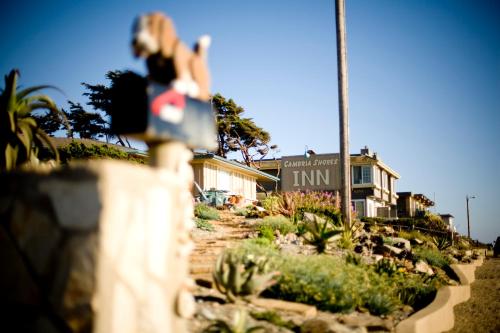 a person holding a skateboard in front of a house at Cambria Shores Inn in Cambria