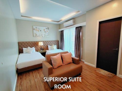 a hotel room with a bed and a couch at Ambien's Place Residential Hotel in Dagupan