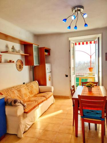 a living room with a couch and a table at Una Terrazza su Como - Vista Panoramica in Brunate
