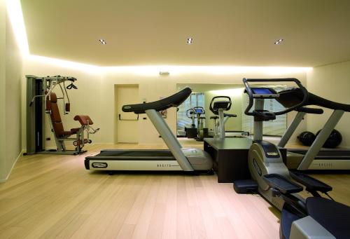 a gym with a treadmill and elliptical machines at Hotel Ovest in Piacenza