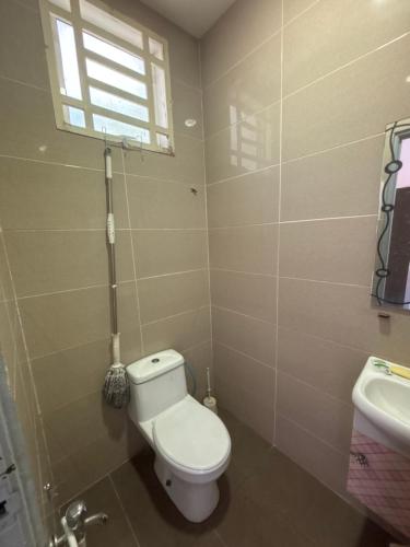 a bathroom with a toilet and a sink at DD Empire Homestay in Jeram