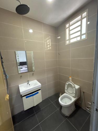 a bathroom with a toilet and a sink at DD Empire Homestay in Jeram