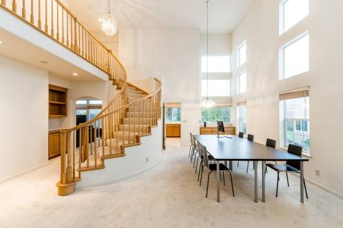 a dining room with a table and a staircase at Affordable Dorm SSF in South San Francisco