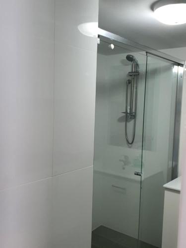 a bathroom with a shower with a glass door at Bayview Bay Apartments and Marina in Gold Coast