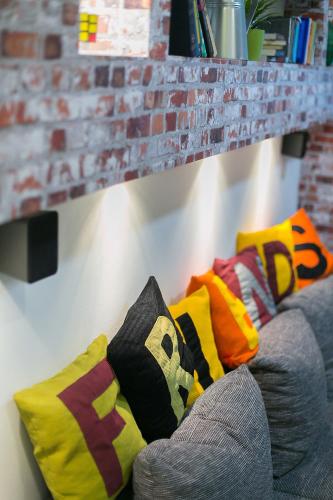 a couch with colorful pillows on it at Friends Hostel & Apartments in Budapest