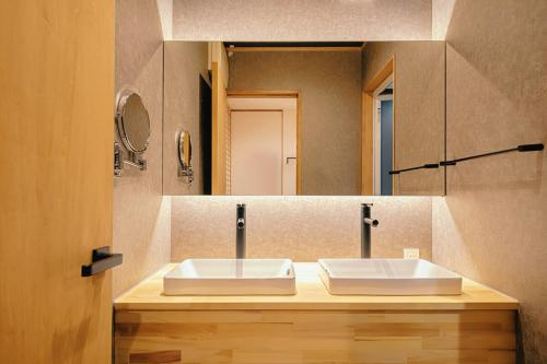 a bathroom with a sink and a mirror at 如意二条城Ruyi Nijojo in Kyoto