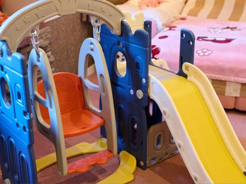 a childs bedroom with a play set and a bunk bed at Ikaho no mori Kids Paradise in Ikaho