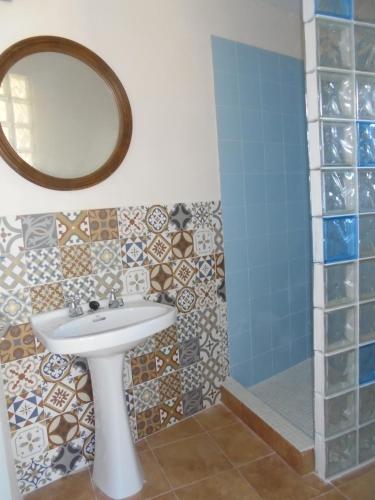 a bathroom with a sink and a mirror and a shower at La Casita in Manacor