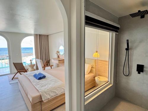 a bedroom with a bed and a view of the ocean at Villa Đại Dương View Biển Đảo Phú Quý in Cu Lao Thu
