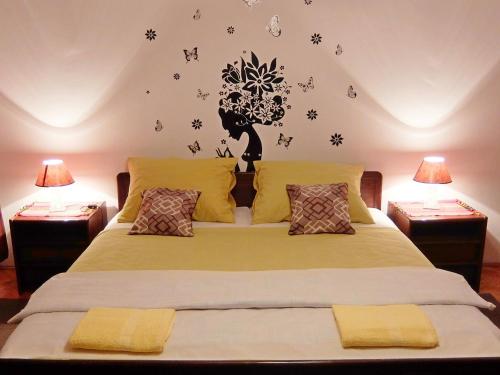 a bedroom with a bed with flowers and butterflies on the wall at Apartment Rendulic in Rakovica