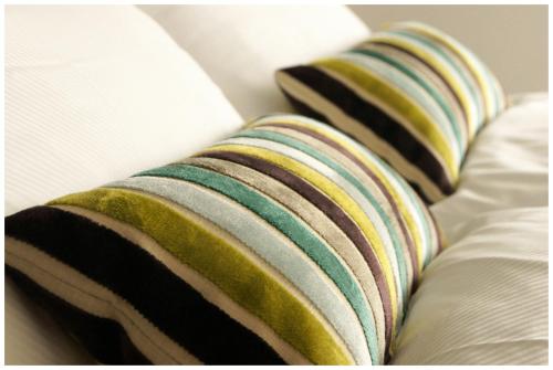 two pillows sitting on top of a bed at PLATZHIRSCH ZÜRICH - Downtown Boutique Hotel & Sushi Lounge in Zürich