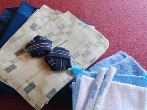 two pieces of cloths and toothbrushes on a table at Minshuku Shima in Kaga