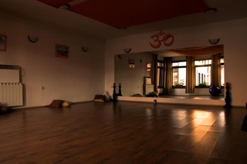 an empty room with a wooden floor and a large window at Hotel Ida in Bansko